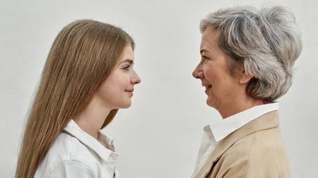 Smiling girl and grandmother looking at each otherの写真素材