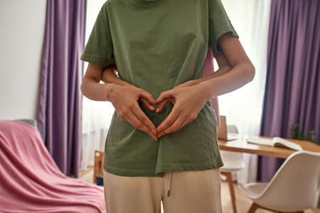 Cropped image of girl hug her girlfriend at homeの写真素材