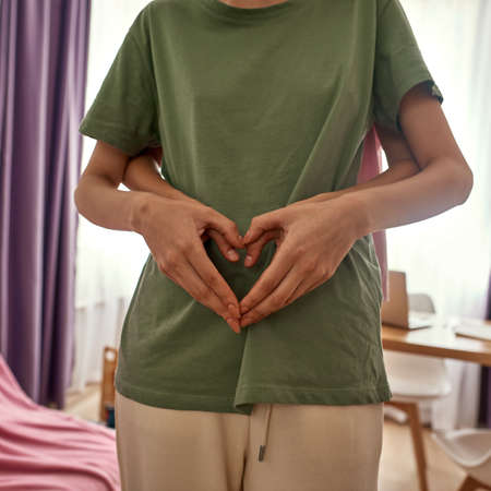 Partial image of girl hugging girlfriend at home