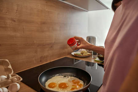Cropped image of girls cook breakfast at kitchenの写真素材
