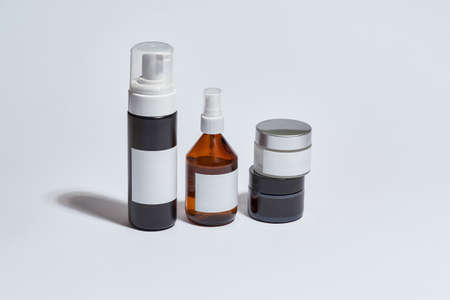 Cosmetological bottles for daily care with empty labels