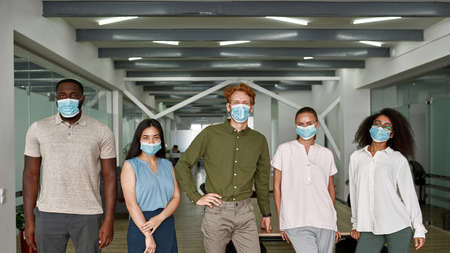 Multiracial people in medical masks in officeの写真素材