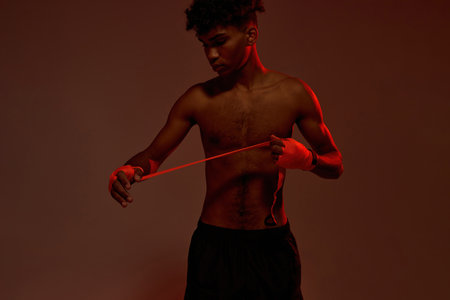 Cropped of male boxer wrapping bandage on handの写真素材