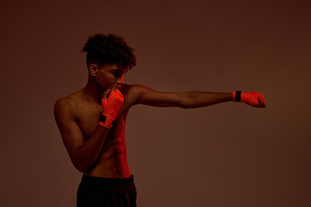 Side view of black serious male boxer boxingの写真素材