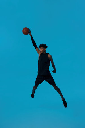 Basketball player jump and throw basketball ball