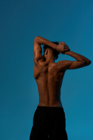 Back view of sportsman stretch before trainingの写真素材