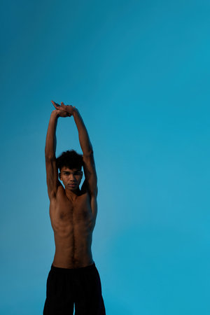 Young curly black serious sports man stretchingの写真素材