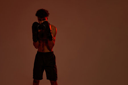 Serious male boxer look at camera during trainingの写真素材