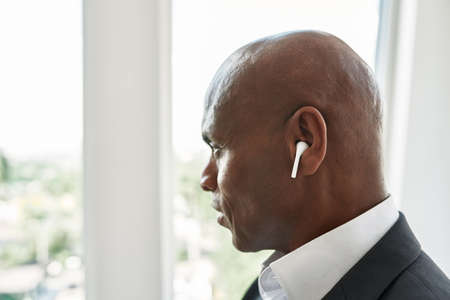Profile of black male businessman look from window