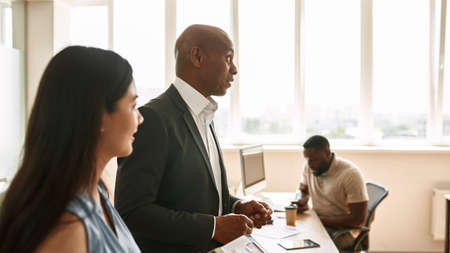 Boss tell company strategy at meeting in officeの写真素材