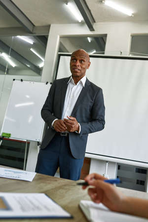 Surprised black male boss at company meeting
