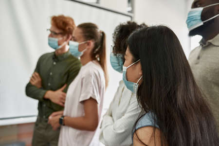 Employees listening and looking on boss at meetingの写真素材