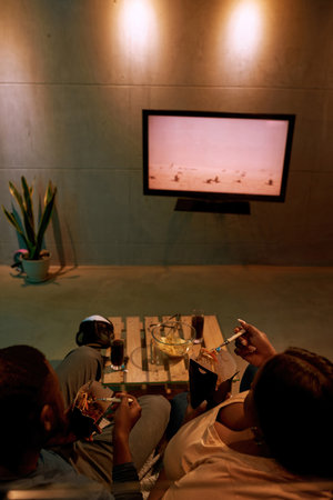 Black couple eat fast food and watch TV or movie