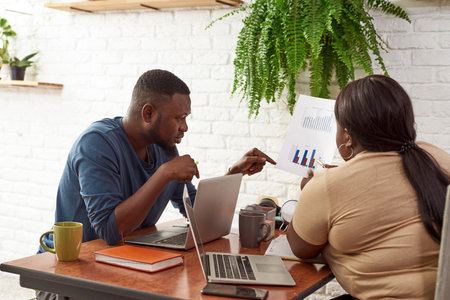 Man and girl look and point on business chartの写真素材