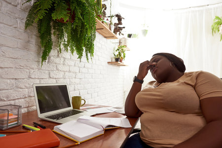 Female market trader with migraine working at home