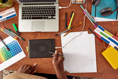 Female designer drawing in graphics tablet at homeの写真素材