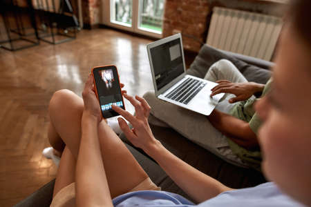 Blogger couple editing video on digital devicesの写真素材