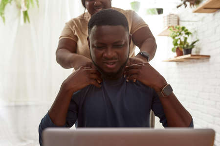 Obscure face of girl doing massage to boyfriend