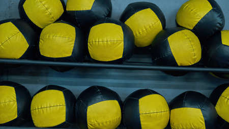 Partial of set of sport balls on shelves in gymの写真素材