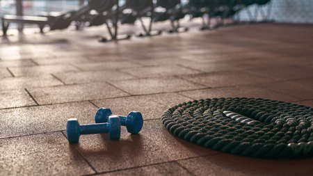 Focus on foreground of sports rope and dumbbellsの写真素材