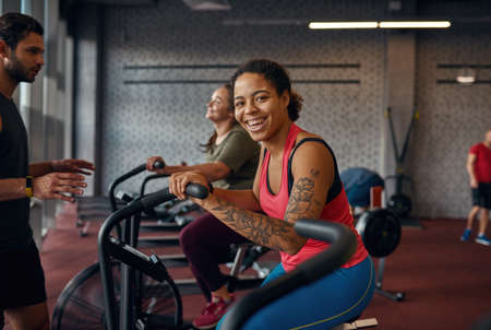 Girl doing exercise on orbitrek with girlfriend