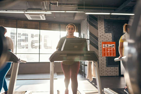 Partial of multiracial girls running on treadmillの写真素材