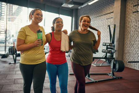 Pleased girls hugging and going after trainingの写真素材