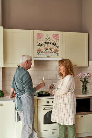 Senior caucasian couple cooking at home kitchenの写真素材