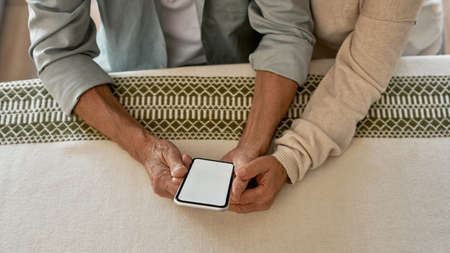 Partial of mature couple use and browse smartphoneの写真素材