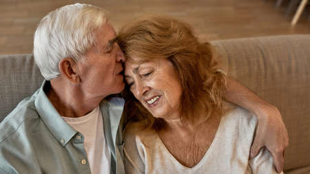 Partial of senior caucasian couple resting on sofa