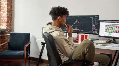 Top view of african american trader having lunch with fast foodの写真素材