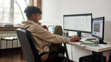 Worried stressed african american trader vaping and watching data index chart stock market