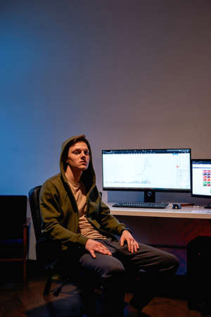Confident male with stock market graph on computer