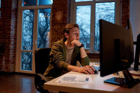 Trader or businessman use and watch on computerの写真素材