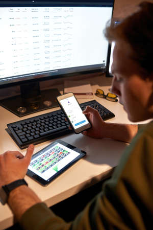 Trader watching and monitoring stock market online