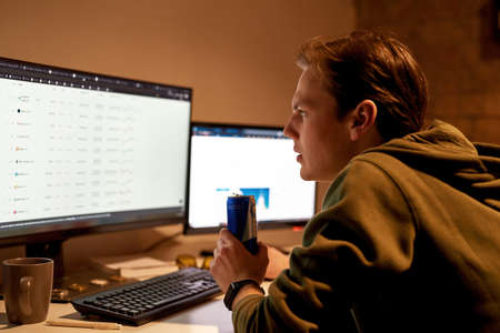 Concentrated male trader watching on market data