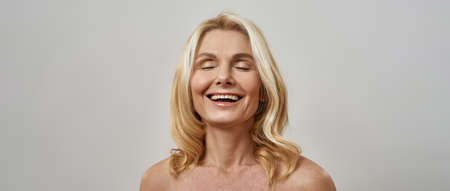 Middle aged caucasian woman laugh with closed eyes