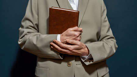 Partial image of business woman holding notebook