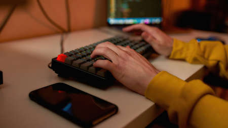 Cropped of IT developer type on computer keyboardの写真素材