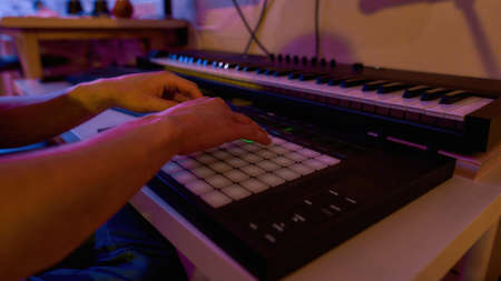 Partial of male musician playing music controller