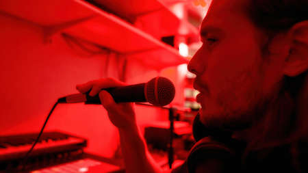 Cropped of male singer singing song at home studio