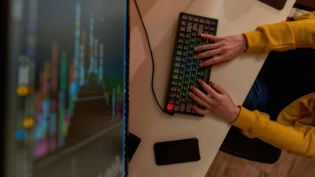 IT developer typing script on computer at home