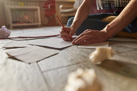 Cropped image of man writing text of new song
