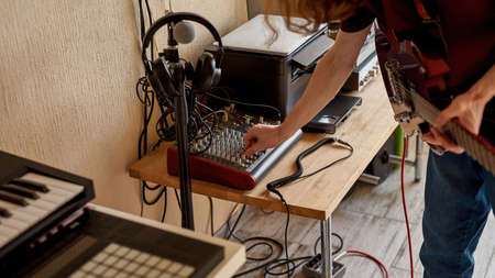 Man turn sound control mixer for settings guitarの写真素材