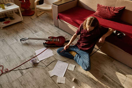Top view of focused man think about text of song