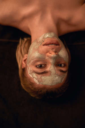 Portrait of girl with clay mask on face in spaの写真素材