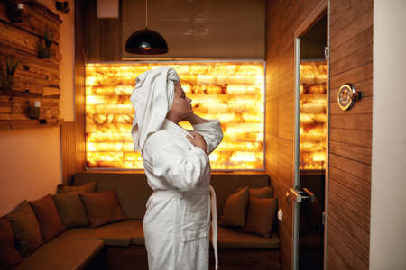 Side view of girl look at herself in mirror in spaの写真素材