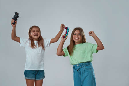 Girls celebrating success in playing video gameの写真素材