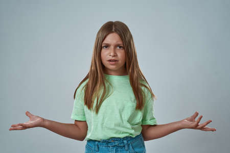Front view of little girl with skeptical faceの写真素材