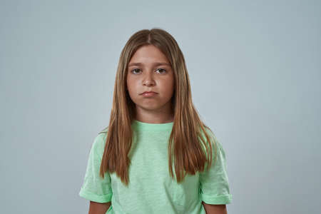 Front view of serious little girl look at cameraの写真素材